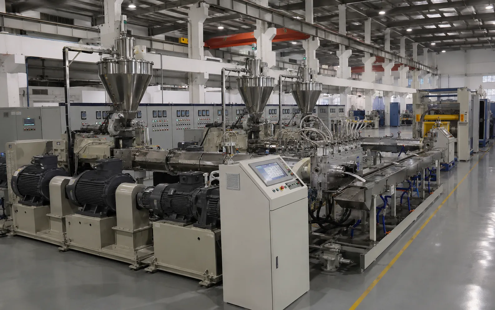 Multi-layer co-extrusion line with three stainless steel hoppers, three industrial motors and tandem extruder configuration PLC synchronized for applying inner semi-con insulation and outer semi-con in single pass for specialty power cables at UET Machine factory