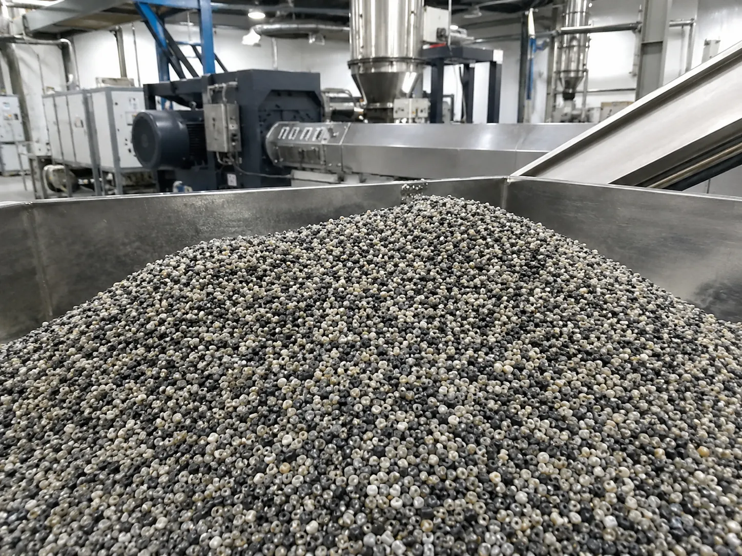 Recycled plastic pellets in stainless steel hopper for clean uniform pellet production