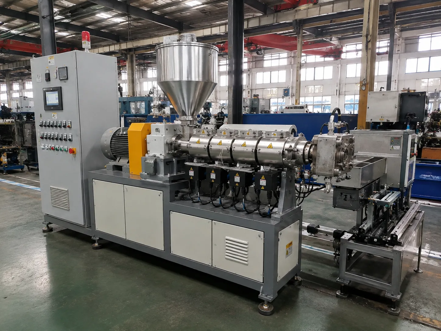 UET-50 compact PVC extruder with 50mm nitrided 42CrMo screw, 18kW motor, PLC touchscreen control and stainless steel hopper for conduits small pipes and trims at UET Machine factory