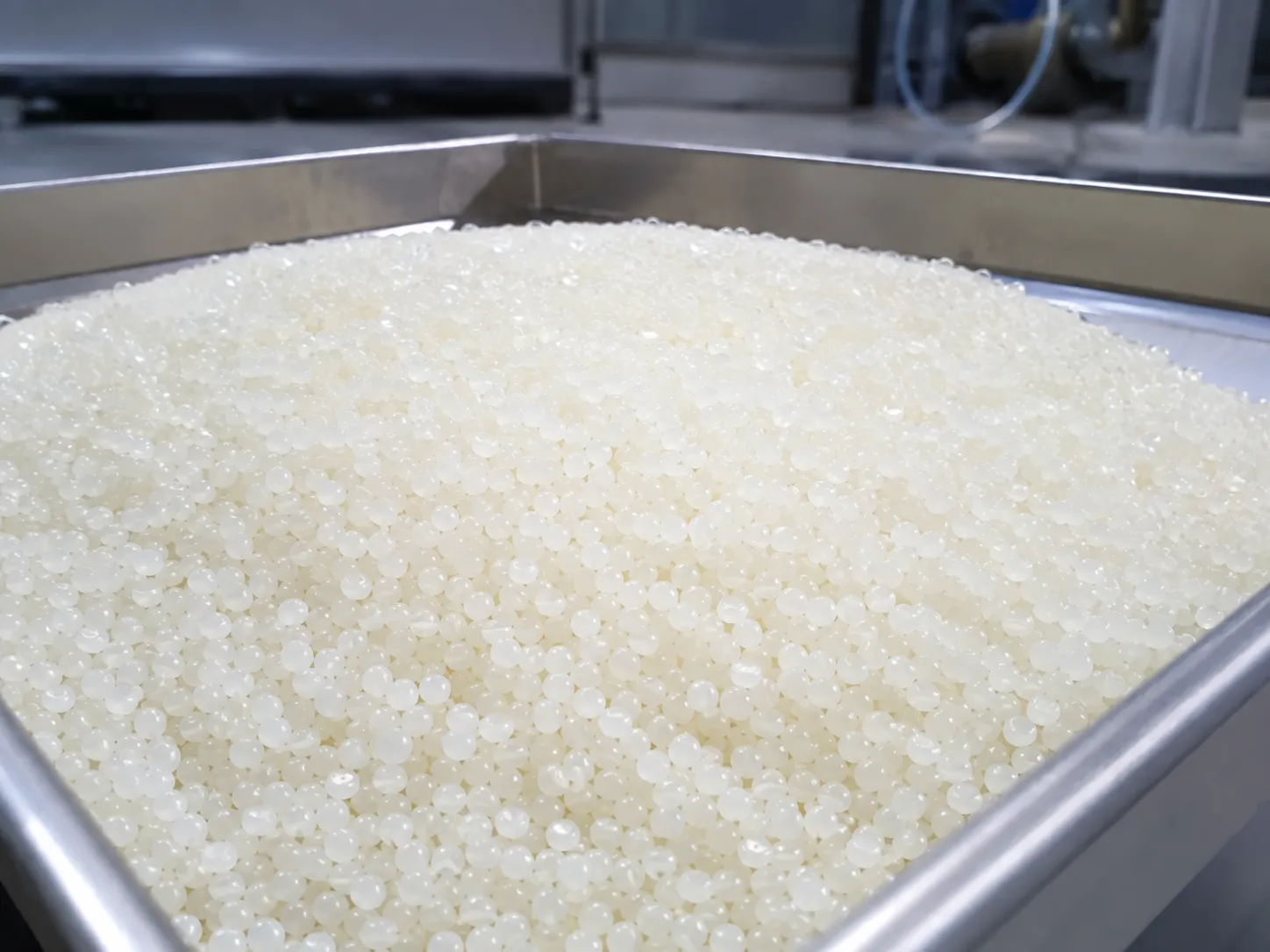 Biodegradable PLA/PBAT pellets with glossy surface, processed by underwater pelletizer for eco-friendly packaging and disposable products.