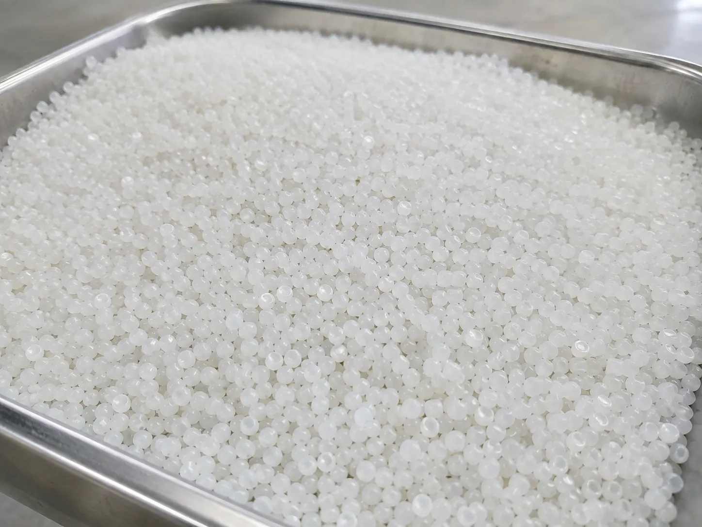 Engineering plastic PA/PBT/PC pellets in pure white, high-density and uniform, processed by underwater pelletizing system for high-strength mechanical parts.