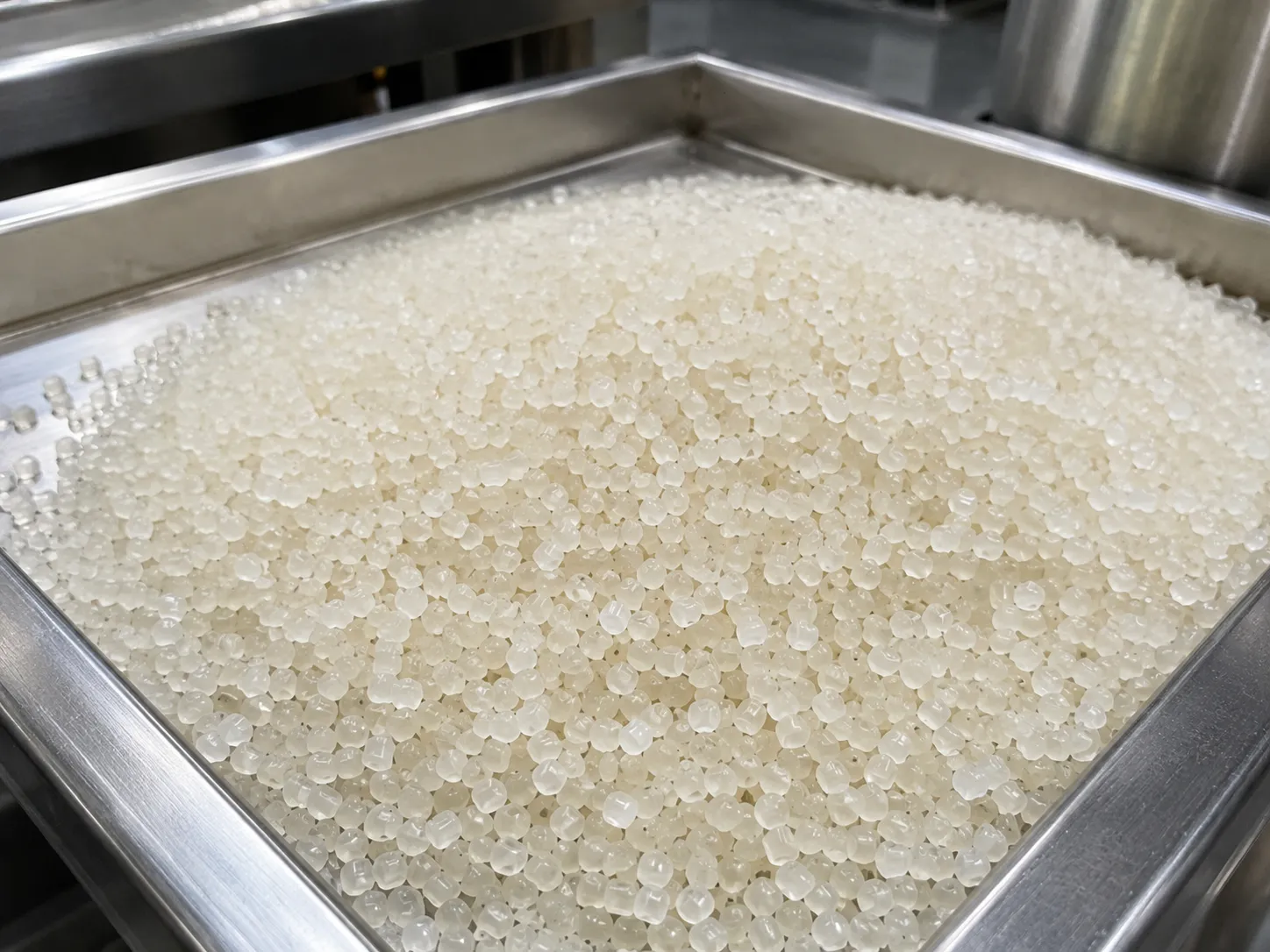 Thermoplastic elastomer TPU/TPE pellets produced via underwater pelletizer, milky white and slightly translucent, used in flexible consumer goods and automotive seals.