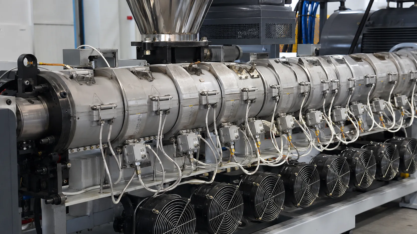 Cast aluminum heaters and cooling fans on zoned barrel of recycled plastic extruder at UET Machine